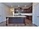 Modern kitchen with granite island, stainless steel appliances, and dark wood cabinets at 6104 Ripple Way # 50, South Fulton, GA 30349