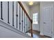 Bright entryway with hardwood floors, an interior door, and a wooden staircase at 6104 Ripple Way # 50, South Fulton, GA 30349