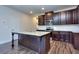 Modern kitchen with granite island, stainless steel appliances, and dark wood cabinets at 6104 Ripple Way # 50, South Fulton, GA 30349