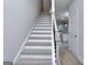 Modern staircase with gray washed wood treads and black spindles at 6116 Ripple Way # 47, South Fulton, GA 30349