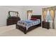 Comfortable bedroom with a queen-size bed and wood furniture at 3756 Bondurant Dr, Douglasville, GA 30135