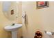 Convenient half bathroom with pedestal sink and oval mirror at 3756 Bondurant Dr, Douglasville, GA 30135