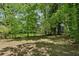 Large grassy backyard surrounded by lush trees, providing ample privacy at 1886 S Gordon Sw St, Atlanta, GA 30310