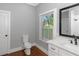 Bathroom with white vanity, toilet and window at 1068 N Main Nw St, Conyers, GA 30012