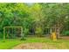 Large backyard with playground and mature trees at 1068 N Main Nw St, Conyers, GA 30012