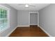 Well-lit bedroom featuring hardwood floors and a closet at 1068 N Main Nw St, Conyers, GA 30012
