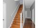Elegant staircase with wooden steps and iron railing at 1068 N Main Nw St, Conyers, GA 30012