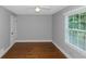 Spacious bedroom with hardwood floors and large window at 1068 N Main Nw St, Conyers, GA 30012