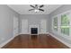 Bedroom with hardwood floors, ceiling fan, fireplace and windows at 1068 N Main Nw St, Conyers, GA 30012