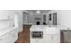 Open kitchen with island, white cabinets, and a view to the living room at 1068 N Main Nw St, Conyers, GA 30012