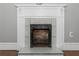 A white marble fireplace with a black metal grate at 1068 N Main Nw St, Conyers, GA 30012
