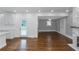 Open floor plan, hardwood floors, and white kitchen at 1068 N Main Nw St, Conyers, GA 30012