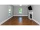 Living room with hardwood floors, fireplace, and ceiling fan at 1068 N Main Nw St, Conyers, GA 30012