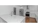 Modern kitchen with white cabinets, stainless steel appliances, and an island at 1068 N Main Nw St, Conyers, GA 30012