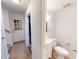 Convenient half bathroom with pedestal sink and toilet at 5332 Zachary Dr, Stone Mountain, GA 30083