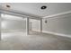 Large open basement area with tile flooring and multiple access points at 6159 Fernstone Nw Ct, Acworth, GA 30101