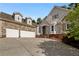 Stone and shingle three-car garage home with a brick facade at 6159 Fernstone Nw Ct, Acworth, GA 30101
