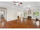 Large living room with hardwood floors, fireplace and ceiling fan at 6159 Fernstone Nw Ct, Acworth, GA 30101