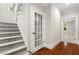 Elegant staircase with gray carpeting and hardwood floors at 6159 Fernstone Nw Ct, Acworth, GA 30101