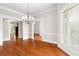 Formal dining room with hardwood floors, chandelier and views to other rooms at 6159 Fernstone Nw Ct, Acworth, GA 30101