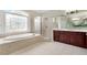 Bathroom with soaking tub, shower, and vanity at 6159 Fernstone Nw Ct, Acworth, GA 30101