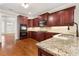 Spacious kitchen with granite countertops and dark wood cabinets at 6159 Fernstone Nw Ct, Acworth, GA 30101