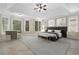 Large main bedroom with hardwood floors, a ceiling fan and large windows at 6159 Fernstone Nw Ct, Acworth, GA 30101