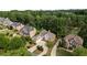 Luxury homes nestled in a wooded community with paved driveways at 6159 Fernstone Nw Ct, Acworth, GA 30101