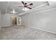 Spacious carpeted bedroom with ceiling fan and access to other rooms at 6159 Fernstone Nw Ct, Acworth, GA 30101