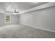 Large bedroom with ceiling fan, carpet, and window at 6159 Fernstone Nw Ct, Acworth, GA 30101
