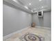 Finished basement room with tile flooring and decorative mosaic at 6159 Fernstone Nw Ct, Acworth, GA 30101