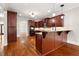 Kitchen with hardwood floors, dark wood cabinets, and granite countertops at 6159 Fernstone Nw Ct, Acworth, GA 30101