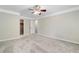 Large bedroom with ceiling fan and neutral carpeting at 6159 Fernstone Nw Ct, Acworth, GA 30101