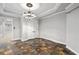 Bright dining room with tile floor, chandelier, and access to basement at 6159 Fernstone Nw Ct, Acworth, GA 30101