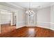 Bright dining room with hardwood floors, chandelier, and crown molding at 6159 Fernstone Nw Ct, Acworth, GA 30101