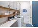 Convenient laundry room with upper cabinets, shelving and patterned floor at 499 Godfrey Dr, Cumming, GA 30040