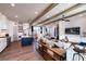 Open concept kitchen and living area with hardwood floors and exposed beams at 499 Godfrey Dr, Cumming, GA 30040