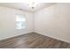 Bright bedroom with wood-look flooring and a large window at 3139 Redwood Run, Atlanta, GA 30349