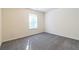 Bright bedroom with grey carpet and large window at 3139 Redwood Run, Atlanta, GA 30349