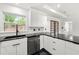 Modern kitchen with white cabinets, black countertops, and stainless steel appliances at 3020 San Jose Dr, Decatur, GA 30032