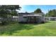 Gray cottage with a small deck and awning, surrounded by a grassy yard at 3525 Hamilton Mill Rd, Buford, GA 30519