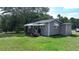 Gray cottage with a small deck and awning, surrounded by a grassy yard at 3525 Hamilton Mill Rd, Buford, GA 30519