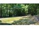 Large grassy backyard, partially shaded by trees at 3525 Hamilton Mill Rd, Buford, GA 30519