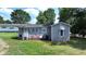 Gray cottage with a small front porch, surrounded by a grassy yard at 3525 Hamilton Mill Rd, Buford, GA 30519