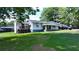 White Ranch home with deck, steps and front porch, surrounded by a grassy yard at 3525 Hamilton Mill Rd, Buford, GA 30519