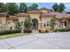 Elegant home exterior with ornate entryway and lush landscaping at 1608 Golden Creek Sw Ct, Conyers, GA 30094