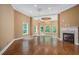 Bright living room with hardwood floors, fireplace, and large windows at 1608 Golden Creek Sw Ct, Conyers, GA 30094