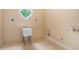 Unfinished laundry room with a utility sink and tile flooring at 1608 Golden Creek Sw Ct, Conyers, GA 30094