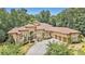 Impressive luxury home with a large driveway and mature trees surrounding the property at 1608 Golden Creek Sw Ct, Conyers, GA 30094