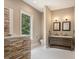 Bathroom with stone accent wall and double vanity at 1608 Golden Creek Sw Ct, Conyers, GA 30094